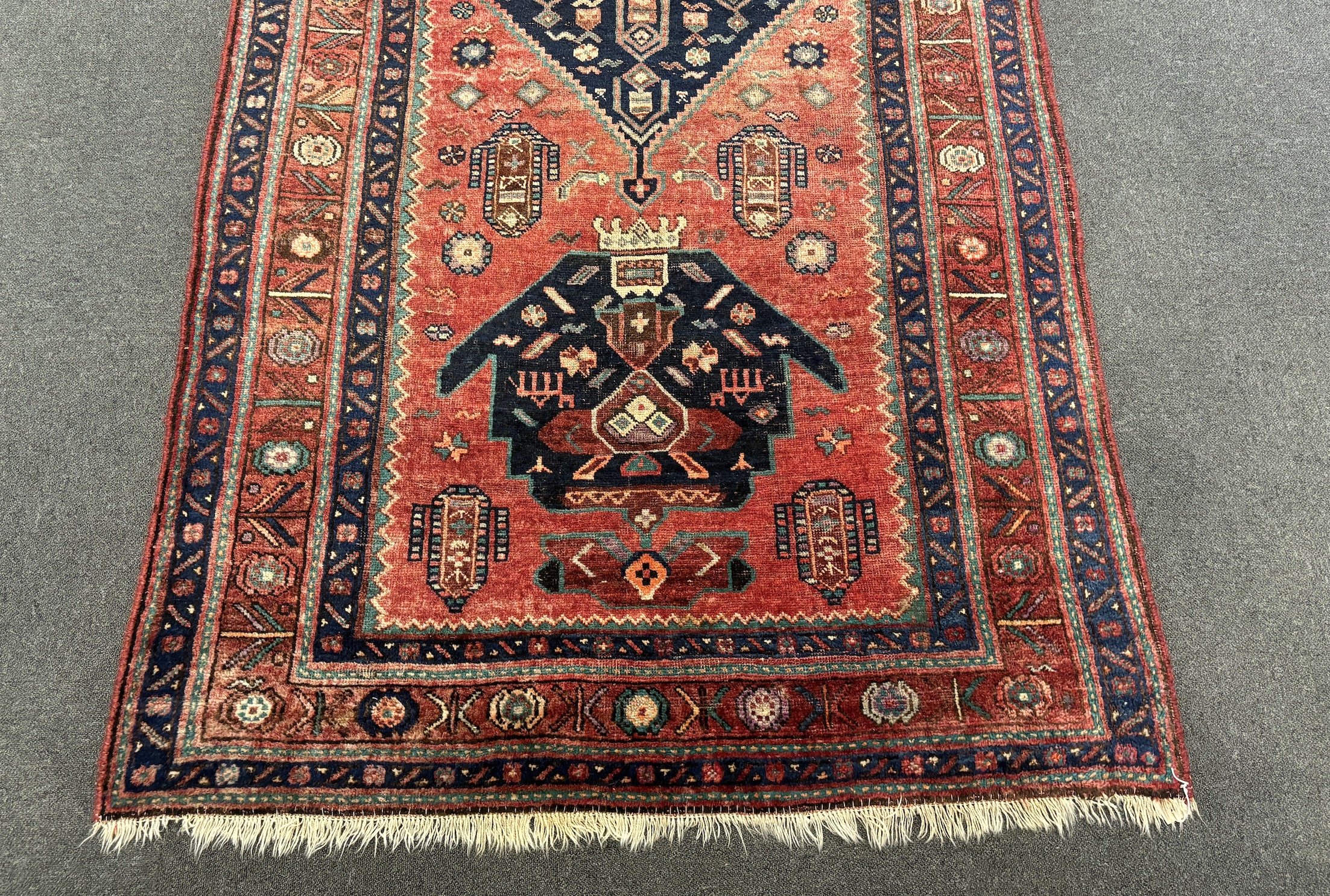 An Heriz red ground medallion rug 280 x 137cm